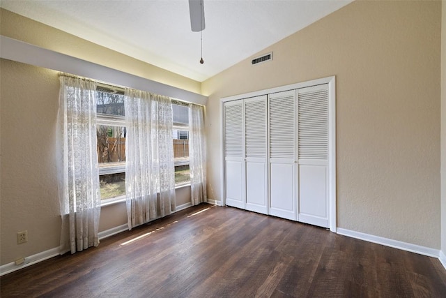 1310 Thompson St, Taylor, TX 76574 - unfurnished bedroom with lofted ceiling, dark wood finished floors, a closet, and a ceiling fan