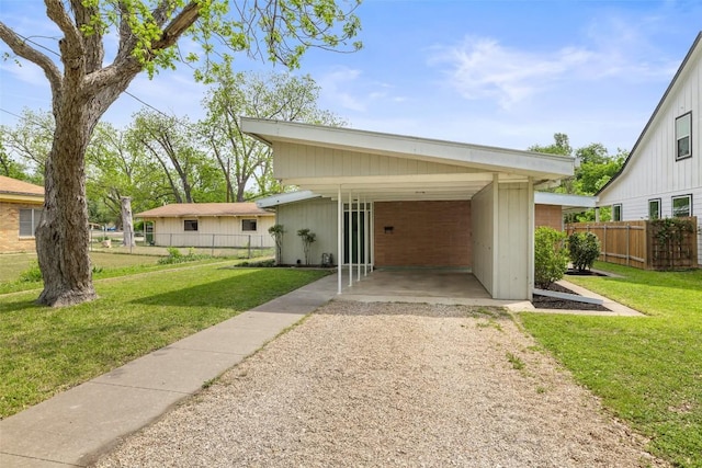 1310 Thompson St, Taylor, TX 76574 - view of front facade with driveway and a carport