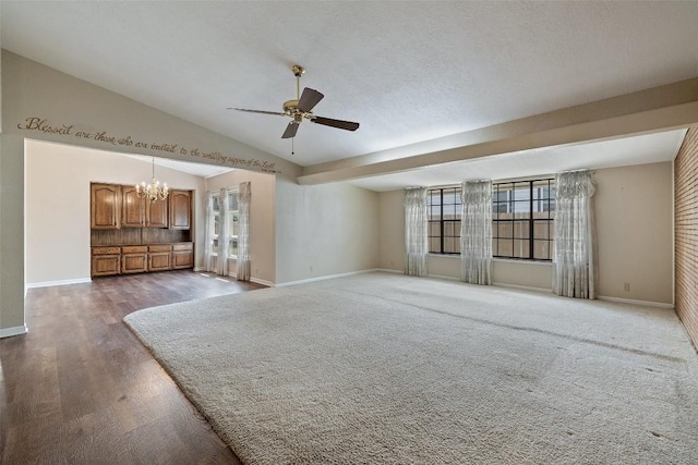 unfurnished living room with wood finished floors, lofted ceiling, baseboards, and ceiling fan with notable chandelier