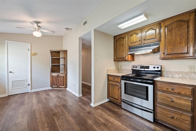 kitchen with a ceiling fan, stainless steel electric range oven, light countertops, under cabinet range hood, and visible vents
