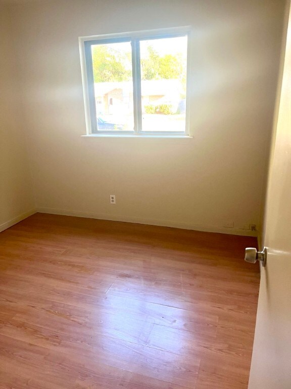 6410 Middleham Pl, Austin, TX 78745 - spare room with light wood-style floors and baseboards