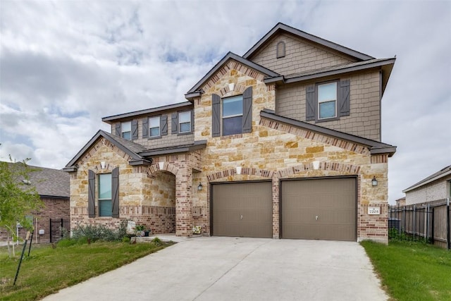 view of front of house featuring a front lawn, driveway, stone siding, fence, and an attached garage