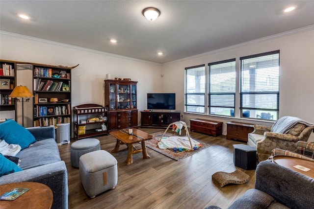 living area featuring ornamental molding, wood finished floors, and recessed lighting