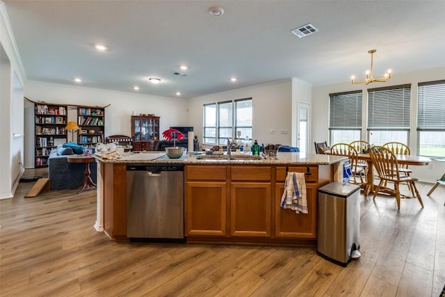 kitchen featuring an inviting chandelier, dishwasher, open floor plan, and a sink