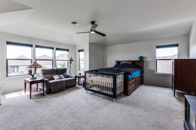 carpeted bedroom featuring ceiling fan, baseboards, lofted ceiling, and visible vents