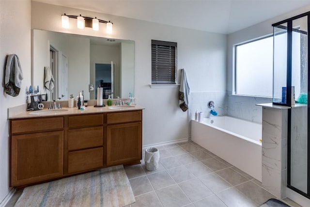 full bathroom featuring tile patterned flooring, a garden tub, a sink, and double vanity