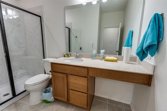 bathroom featuring a marble finish shower, tile patterned flooring, and vanity