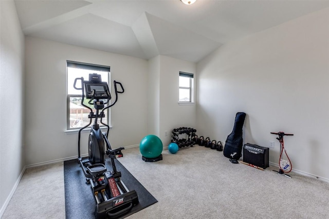 workout area featuring lofted ceiling, baseboards, and carpet floors