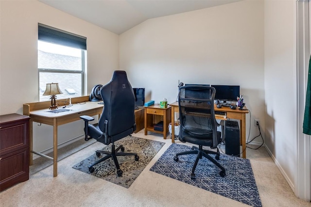 office with lofted ceiling, light carpet, and baseboards