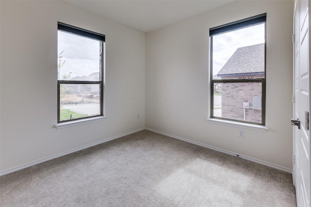 carpeted empty room with baseboards
