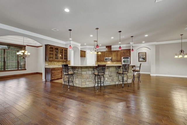 116 San Salvadore Dr, Canyon Lake, TX 78133 - kitchen featuring a chandelier, appliances with stainless steel finishes, baseboards, backsplash, and crown molding