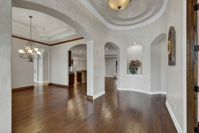 116 San Salvadore Dr, Canyon Lake, TX 78133 - spare room with a raised ceiling, dark wood-style flooring, ornamental molding, a chandelier, and baseboards