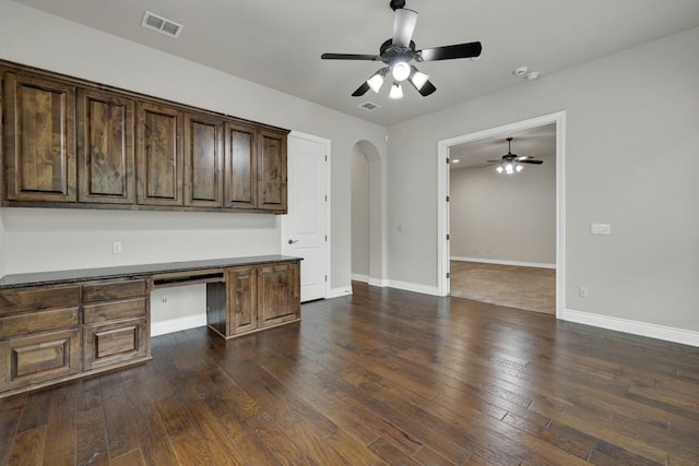 116 San Salvadore Dr, Canyon Lake, TX 78133 - unfurnished office featuring a ceiling fan, built in study area, arched walkways, dark wood finished floors, and baseboards