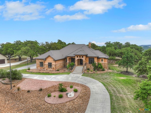 116 San Salvadore Dr, Canyon Lake, TX 78133 - view of front facade featuring a standing seam roof, curved driveway, a chimney, and metal roof