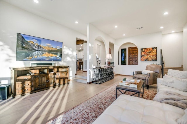 living room featuring recessed lighting, wood finished floors, and visible vents