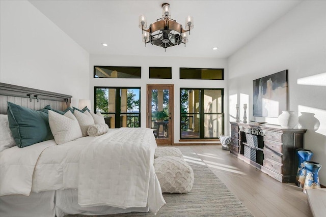bedroom featuring recessed lighting, wood finished floors, and a notable chandelier