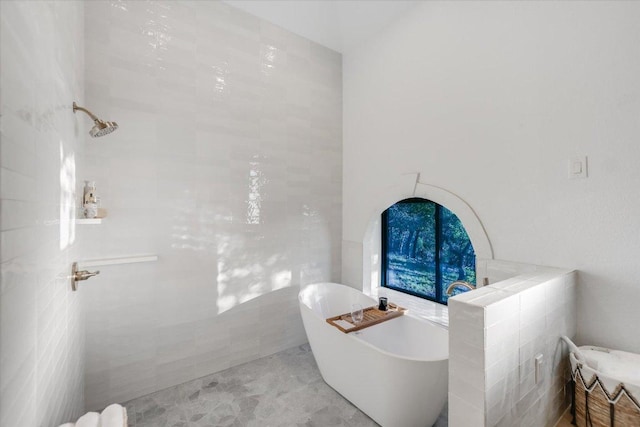 full bath with a freestanding bath and tiled shower