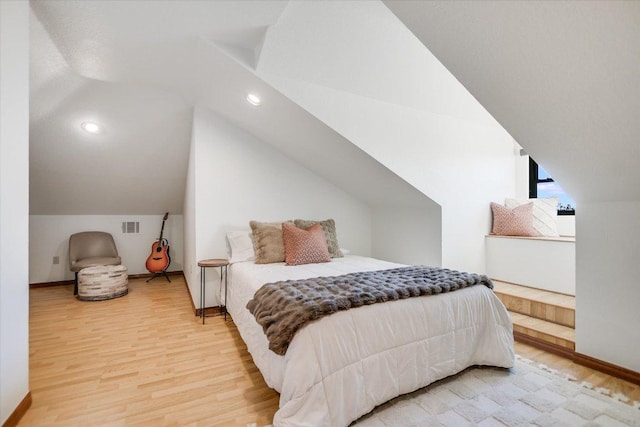 100 Mesa Dr, Wimberley, TX 78676 - bedroom featuring light wood finished floors, lofted ceiling, baseboards, and recessed lighting