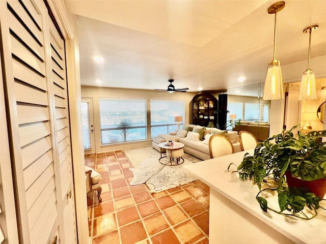 living area featuring a ceiling fan and light tile patterned flooring