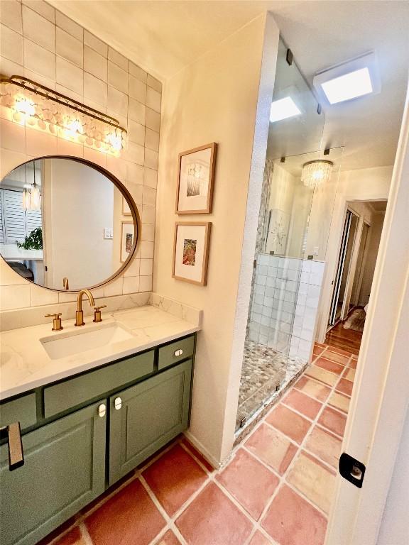 1601 Judy Lynn Dr Unit 107, Spicewood, TX 78669 - bathroom featuring vanity, a shower stall, and tile walls