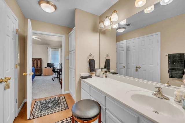 bathroom with vanity, baseboards, and visible vents