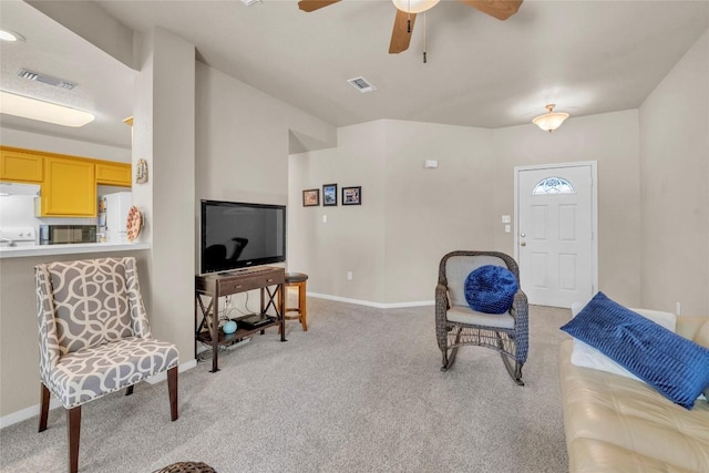 living room with baseboards, light carpet, a ceiling fan, and visible vents