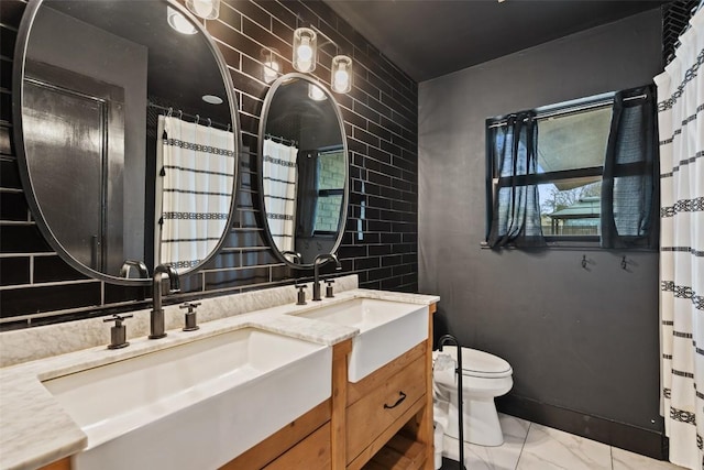 326 W Mulberry St, Fredericksburg, TX 78624 - bathroom with marble finish floor, vanity, and toilet
