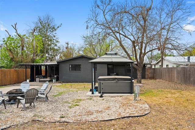 326 W Mulberry St, Fredericksburg, TX 78624 - rear view of house featuring a gazebo, a patio area, an outdoor fire pit, a fenced backyard, and a hot tub