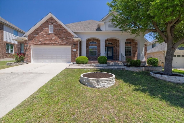 814 Arrowhead Trl, Cedar Park, TX 78613 - view of front of house with a front lawn, driveway, brick siding, a garage, and covered porch
