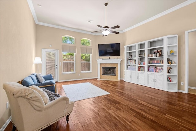 814 Arrowhead Trl, Cedar Park, TX 78613 - living area with a ceiling fan, ornamental molding, wood finished floors, a fireplace with flush hearth, and baseboards
