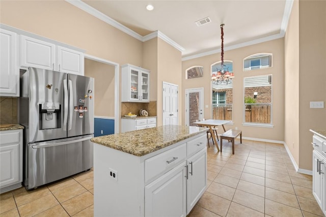 814 Arrowhead Trl, Cedar Park, TX 78613 - kitchen with stainless steel refrigerator with ice dispenser, light tile patterned floors, a chandelier, tasteful backsplash, and ornamental molding