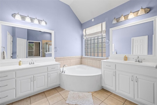 814 Arrowhead Trl, Cedar Park, TX 78613 - bathroom featuring vaulted ceiling, two vanities, tile patterned flooring, and a bath