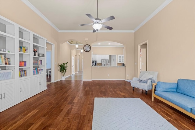 814 Arrowhead Trl, Cedar Park, TX 78613 - living room featuring ceiling fan, crown molding, arched walkways, and dark wood finished floors