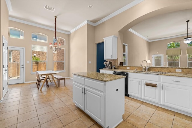 814 Arrowhead Trl, Cedar Park, TX 78613 - kitchen with dishwasher, light tile patterned flooring, arched walkways, a sink, and a kitchen island