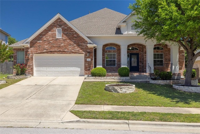 814 Arrowhead Trl, Cedar Park, TX 78613 - view of front of home featuring a front yard, brick siding, driveway, a garage, and roof with shingles