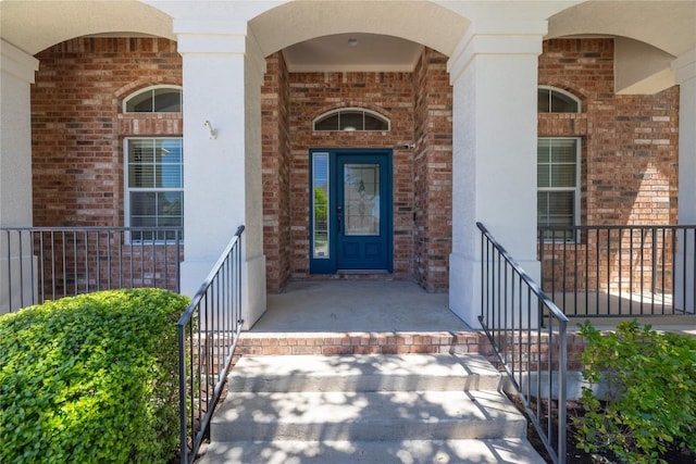 814 Arrowhead Trl, Cedar Park, TX 78613 - view of exterior entry with a porch, brick siding, and stucco siding