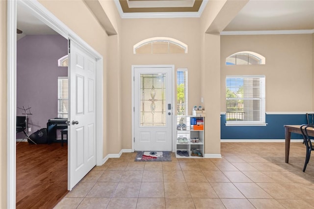 814 Arrowhead Trl, Cedar Park, TX 78613 - entryway featuring baseboards, ornamental molding, a towering ceiling, and light tile patterned floors