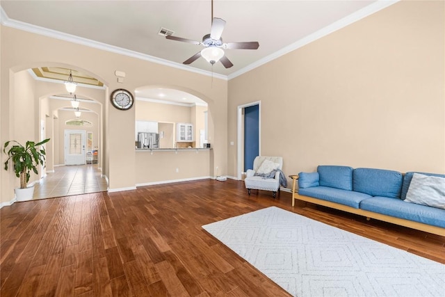 814 Arrowhead Trl, Cedar Park, TX 78613 - living area featuring arched walkways, a ceiling fan, wood finished floors, baseboards, and ornamental molding
