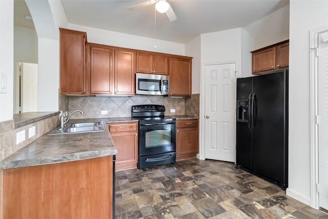 kitchen with a ceiling fan, tasteful backsplash, a sink, brown cabinetry, and black appliances