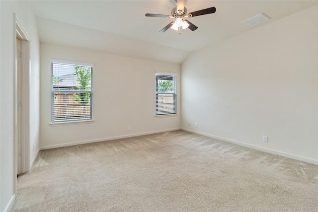 unfurnished room with light carpet, visible vents, and baseboards