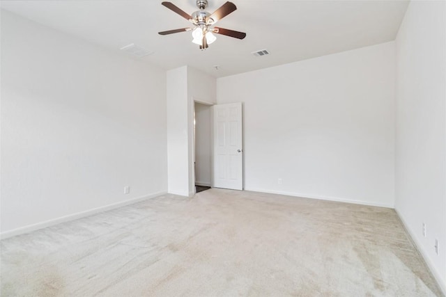 empty room with baseboards, a ceiling fan, visible vents, and carpet