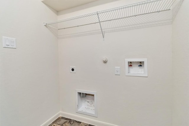 laundry area with laundry area, hookup for an electric dryer, gas dryer hookup, baseboards, and washer hookup