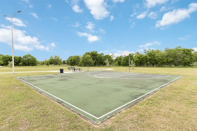 view of sport court featuring a lawn and community basketball court