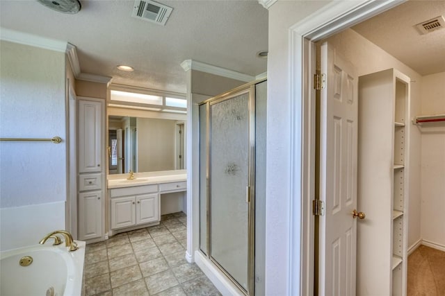 full bathroom featuring a shower stall, visible vents, vanity, and ornamental molding