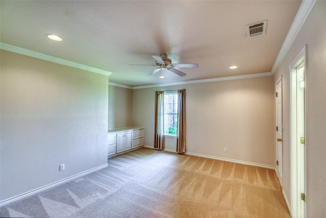 unfurnished room with crown molding, a ceiling fan, baseboards, and light carpet