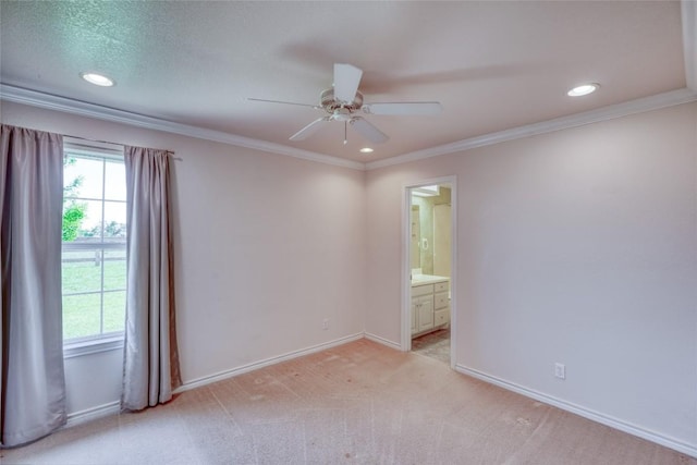 empty room with baseboards, a wealth of natural light, a ceiling fan, and light colored carpet