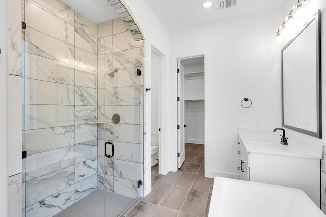 394 Leaning Rock Rdg, Austin, TX 78737 - bathroom with a shower stall, vanity, toilet, tile patterned floors, and a spacious closet