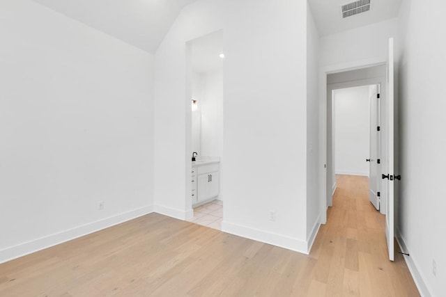 394 Leaning Rock Rdg, Austin, TX 78737 - unfurnished bedroom with light wood-style floors, lofted ceiling, baseboards, and ensuite bath