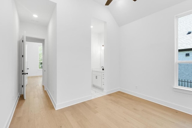 394 Leaning Rock Rdg, Austin, TX 78737 - unfurnished room with light wood finished floors, a ceiling fan, vaulted ceiling, and baseboards