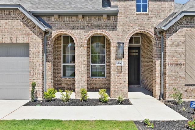 394 Leaning Rock Rdg, Austin, TX 78737 - doorway to property with an attached garage, brick siding, and roof with shingles